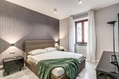 a bedroom with a large bed and a window at R22 Apartment in Rome