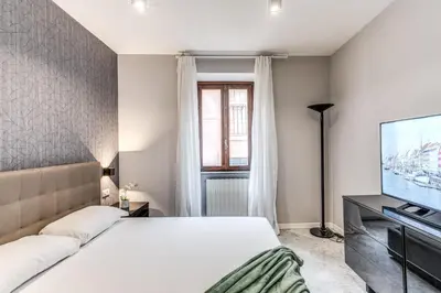 a bedroom with a bed and a flat screen tv at R22 Apartment in Rome