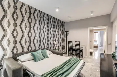 a bedroom with a bed and a wall at R22 Apartment in Rome