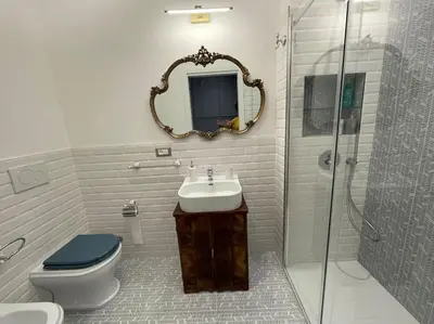 a bathroom with a toilet and a sink and a mirror at Splendido appartamento in Rome