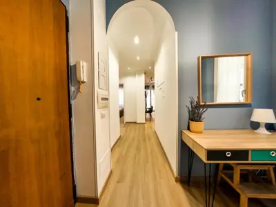 a hallway with an archway and a desk in a room at Chic Modern 2-Bedroom near Metro in Rome