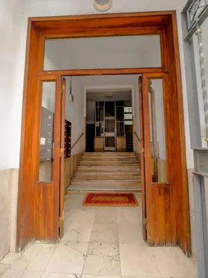 an entrance to a building with a wooden door at Chic Modern 2-Bedroom near Metro in Rome