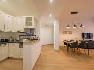 a kitchen and dining room with a table and chairs at Chic Modern 2-Bedroom near Metro in Rome
