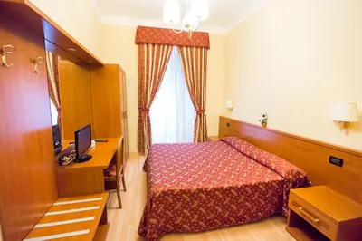 a hotel room with a bed and a television at Funny Palace Hostel in Rome