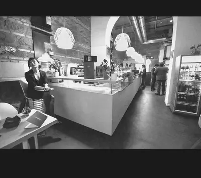 a woman standing at a counter in a restaurant at Funny Palace Hostel in Rome