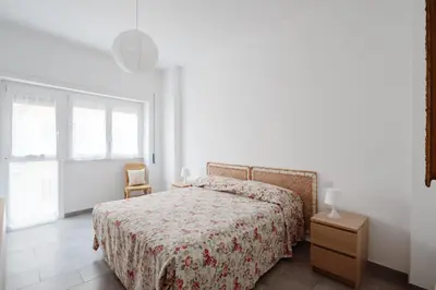 a white bedroom with a bed and a window at Caffarella Park View Rome in Rome