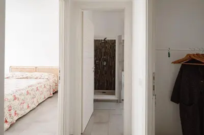 a bedroom with a bed and a walk in shower at Caffarella Park View Rome in Rome