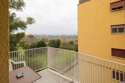 a balcony with a bench and a building at Caffarella Park View Rome in Rome