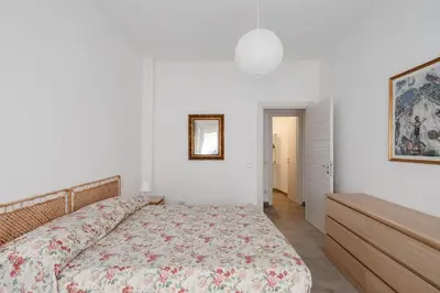 a bedroom with a bed with a floral bedspread at Caffarella Park View Rome in Rome