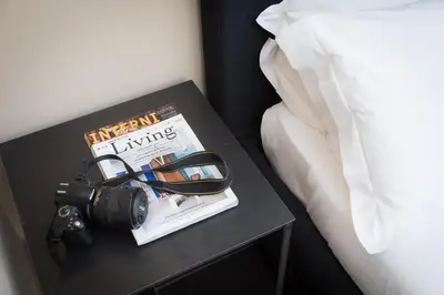a table with a book and a camera and a magazine at App Condotti Luxury Apartment In Rome in Rome