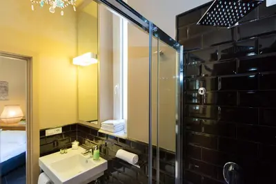 a bathroom with a sink and a mirror at App Condotti Luxury Apartment In Rome in Rome