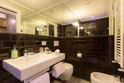a bathroom with a white sink and a toilet at App Condotti Luxury Apartment In Rome in Rome