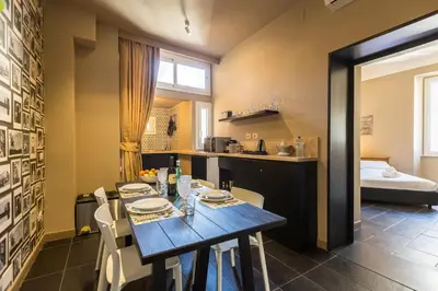 a dining room and kitchen with a table and chairs at App Condotti Luxury Apartment In Rome in Rome