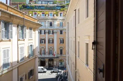 a view of a city street from an alley between buildings at App Condotti Luxury Apartment In Rome in Rome