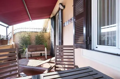 a balcony with a chair and a window at The Attico_Prati in Rome