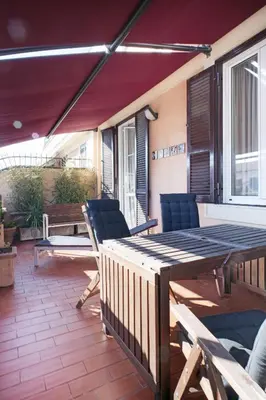a patio with a table and chairs on a deck at The Attico_Prati in Rome