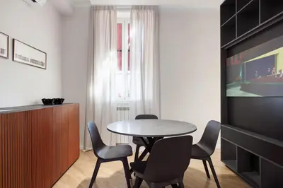 a dining room with a table and chairs at The Attico_Prati in Rome