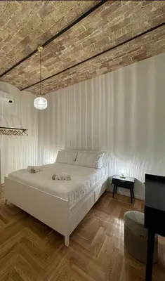 a bedroom with a large white bed in a room at Monti Zen Boutique Apartment-ZEN25 in Rome