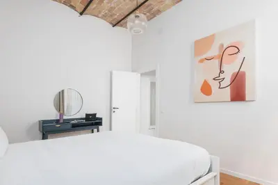 a white bedroom with a bed and a mirror at Monti Zen Boutique Apartment-ZEN25 in Rome
