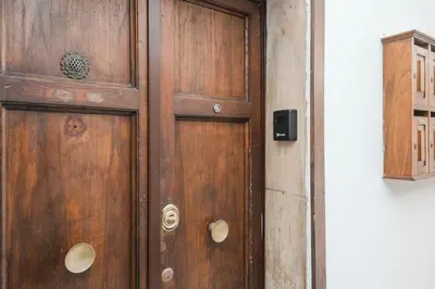 a wooden door in the corner of a room at Monti Zen Boutique Apartment-ZEN25 in Rome
