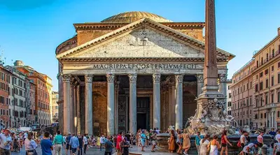 a crowd of people standing outside of a building at Blessed Way in Rome
