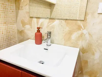 a bathroom sink with a red soap dispenser on it at Locazione Turistica- Maxxi loft in Rome