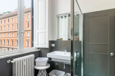 a bathroom with a sink and a window at Aureliana luxury apartment in Rome