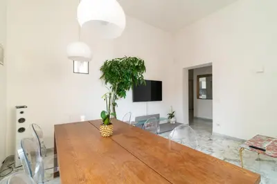 a dining room with a table with a plant on it at Aureliana luxury apartment in Rome