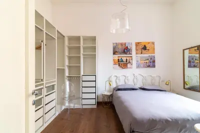 a white bedroom with a bed and a closet at Aureliana luxury apartment in Rome
