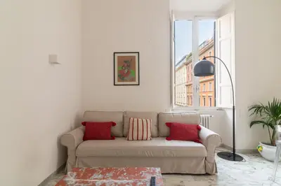 a living room with a couch and a window at Aureliana luxury apartment in Rome