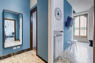 a blue room with a mirror and a stool at BDC - Rome with a view! in Rome