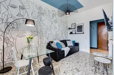 a living room with a wall with a drawing of a woman at BDC - Rome with a view! in Rome