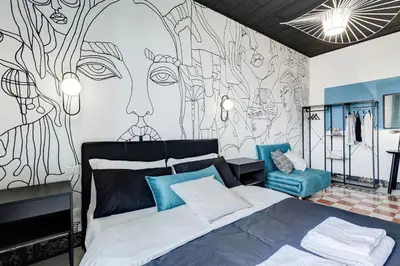 a bedroom with a bed and a wall with a mural at BDC - Rome with a view! in Rome