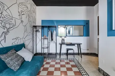 a living room with a blue couch and a table at BDC - Rome with a view! in Rome