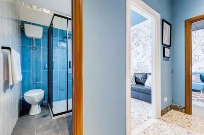a bathroom with a toilet and a glass shower at BDC - Rome with a view! in Rome