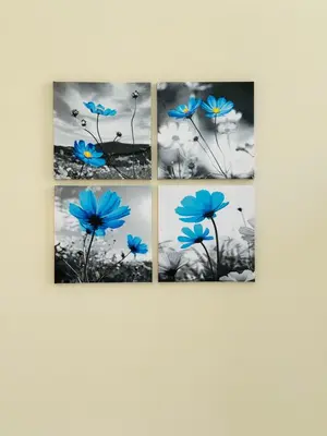 four paintings of blue flowers on a wall at MILLE PARADISO in Rome