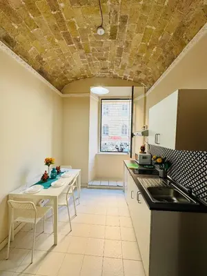 a kitchen with a sink and a table with chairs at MILLE PARADISO in Rome
