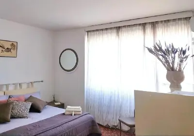 a bedroom with a bed and a large window at 
