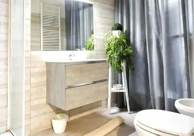 a bathroom with a sink and a toilet and a mirror at 