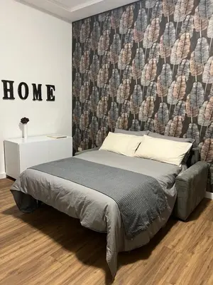 a bedroom with a bed and a wall with a wall at Giuliana Vatican Luxury Home in Rome