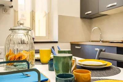 a kitchen with a table with a jar on it at Giuliana Vatican Luxury Home in Rome