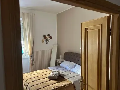 a bedroom with a bed with a shoe on it at Giuliana Vatican Luxury Home in Rome