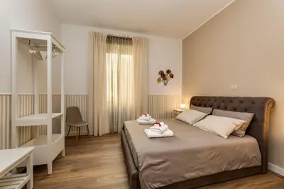 a bedroom with a bed with two towels on it at Giuliana Vatican Luxury Home in Rome