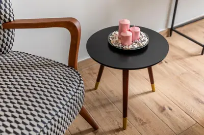 a table with two candles on it next to a chair at Colosseo Road by Hili in Rome