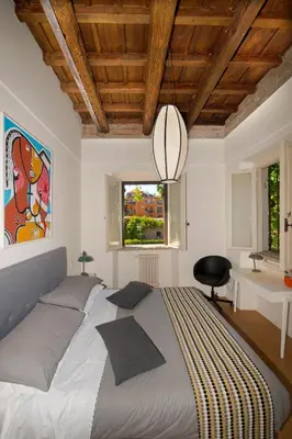 a bedroom with a large bed and a desk at FUORI dal TEMPO Roma Trastevere in Rome