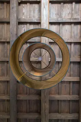 a circular object hanging from a wooden wall at FUORI dal TEMPO Roma Trastevere in Rome