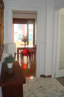 a dining room with a table and red chairs at Apartment Bruno's in Rome