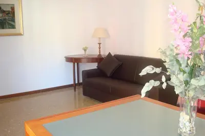 a living room with a couch and a vase of flowers at Apartment Bruno's in Rome