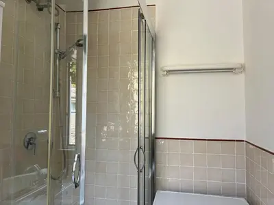 a bathroom with a shower with a toilet and a sink at Appartamento S. Pietro in Rome