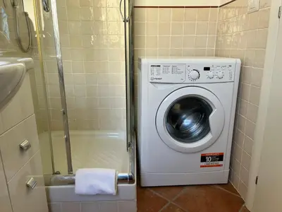 a washing machine in a bathroom with a shower at Appartamento S. Pietro in Rome